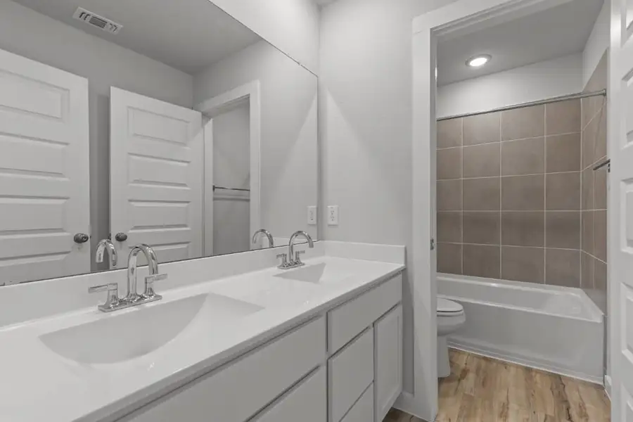 A bathroom with a tub sink and toilet. A bathroom with a tub sink and toilet.