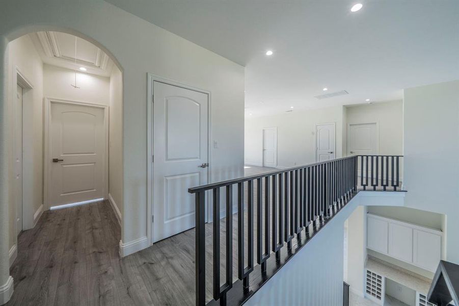 Corridor with attic access, wood finished floors, recessed lighting, and an upstairs landing Corridor with attic access, wood finished floors, recessed lighting, and an upstairs landing