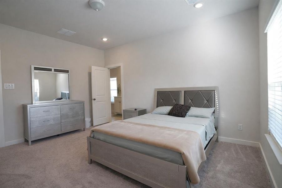 Bedroom featuring light carpet and recessed lighting