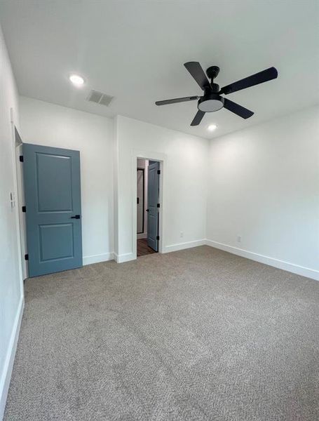 Unfurnished bedroom featuring carpet floors and ceiling fan