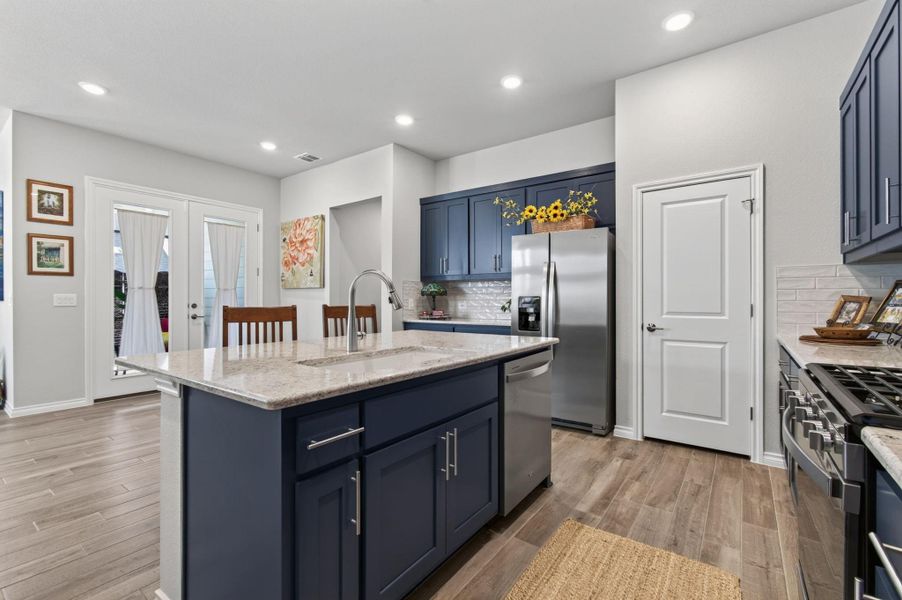 A well-appointed kitchen features a central island, stainless steel appliances, and ample cabinetry for culinary pursuits. A well-appointed kitchen features a central island, stainless steel appliances, and ample cabinetry for culinary pursuits.
