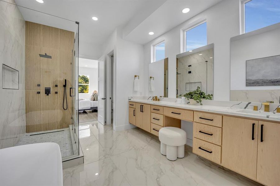 Bathroom featuring vanity, a healthy amount of sunlight, and an enclosed shower