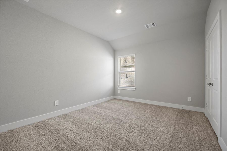 Spacious secondary bedrooms with plush carpet and ample closet space.