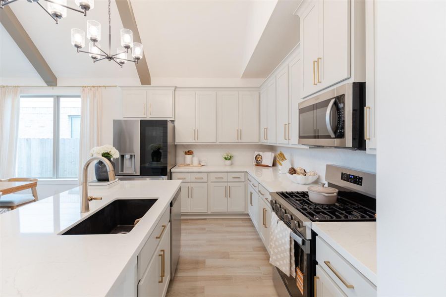 The kitchen boasts a sleek island with a sink and contemporary cabinetry