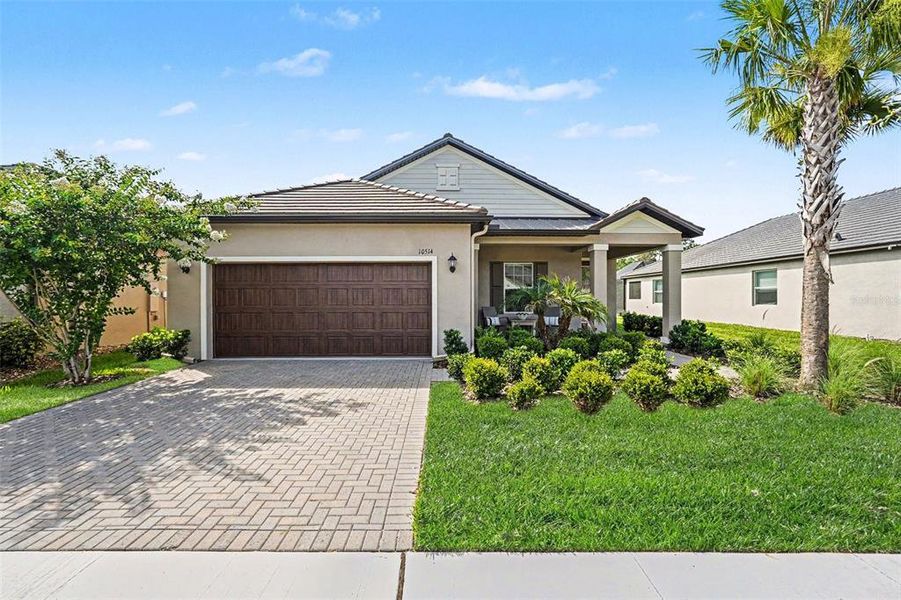 Front exterior of a new home in Angeline Active Adult, Land O' Lakes, FL, highlighting curb appeal (Image 22).
