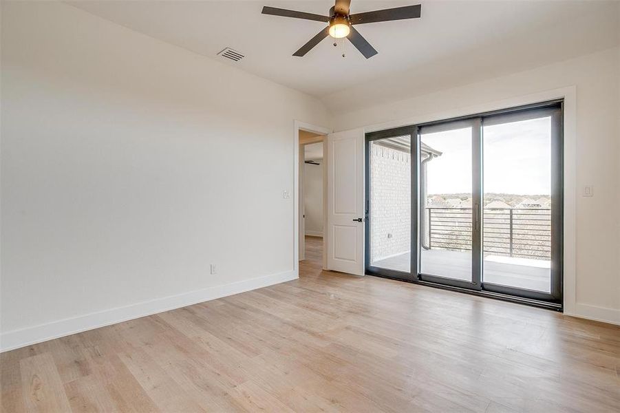 Spare room with visible vents, baseboards, light wood-type flooring, and ceiling fan