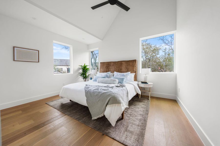 Primary bedroom with vaulted ceilings