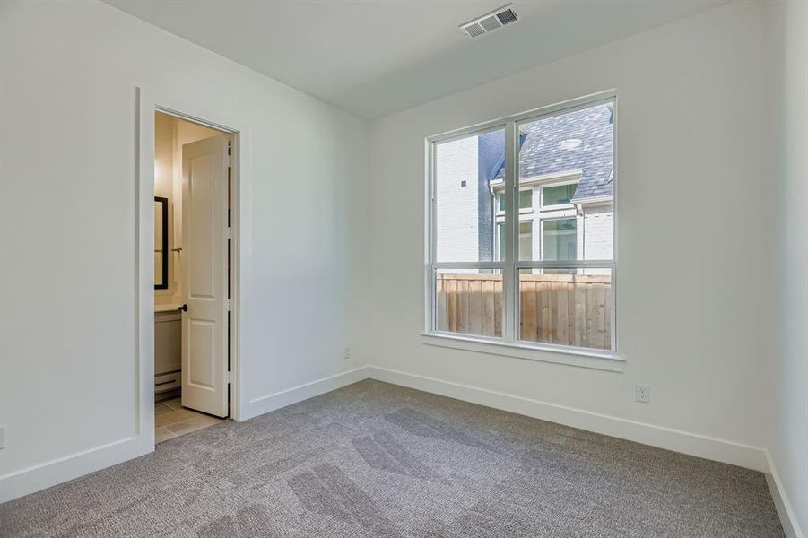 Empty room featuring carpet and baseboards