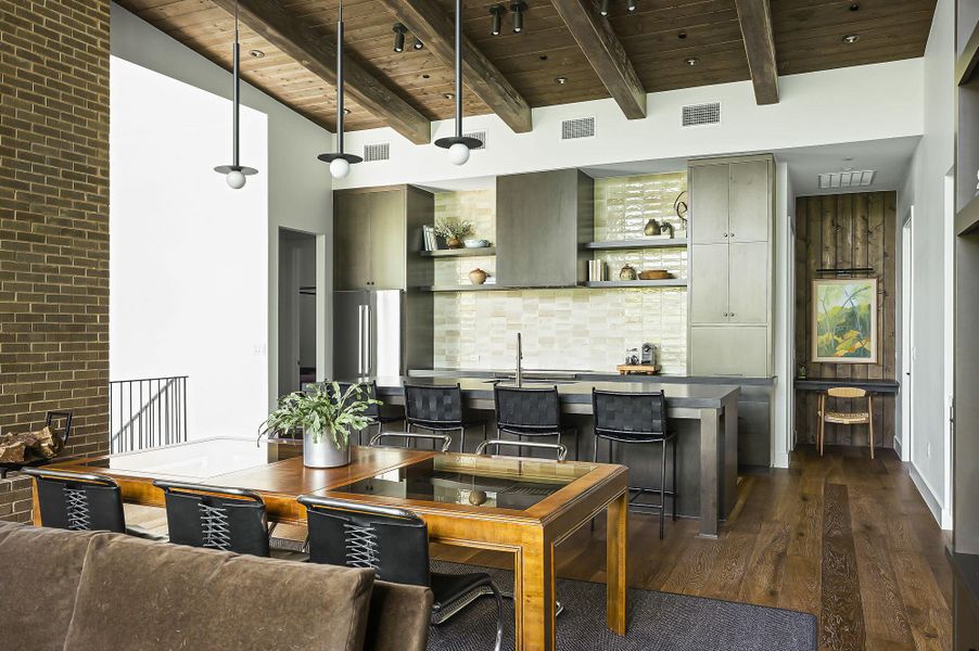 The open Kitchen, Dining and living area are modern, distinctive and chic featuring Bosch appliances and sophisticated hardware