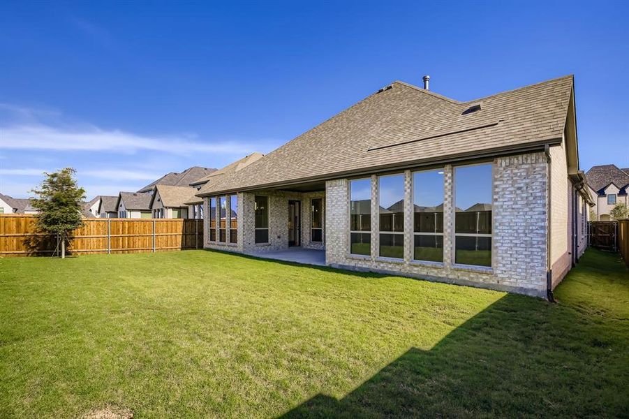 Back of house featuring brick siding, a patio, a shingled roof, and a fenced backyard Back of house featuring brick siding, a patio, a shingled roof, and a fenced backyard