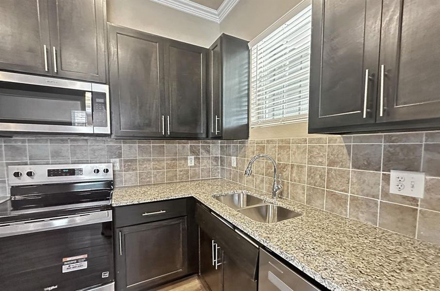 Luxe and still highly functional kitchen has window over sink