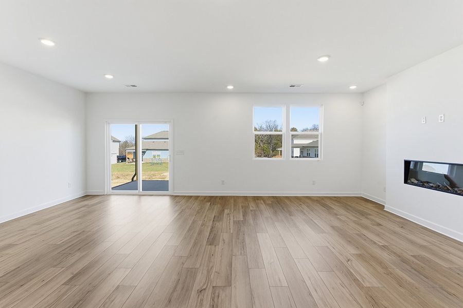 A room with a wood floor and windows.
