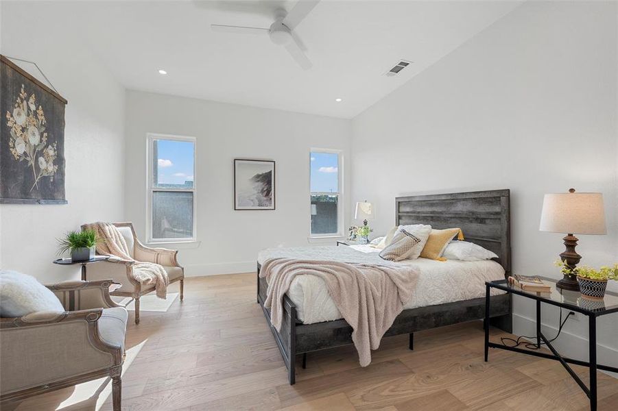 Bedroom with light wood finished floors, recessed lighting, and a ceiling fan Bedroom with light wood finished floors, recessed lighting, and a ceiling fan