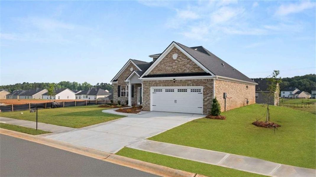 Front exterior of a new home in The Gates at Pates Creek, Hampton, GA, highlighting curb appeal (Image 21).