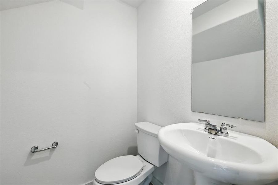 Bathroom featuring toilet and a sink Bathroom featuring toilet and a sink