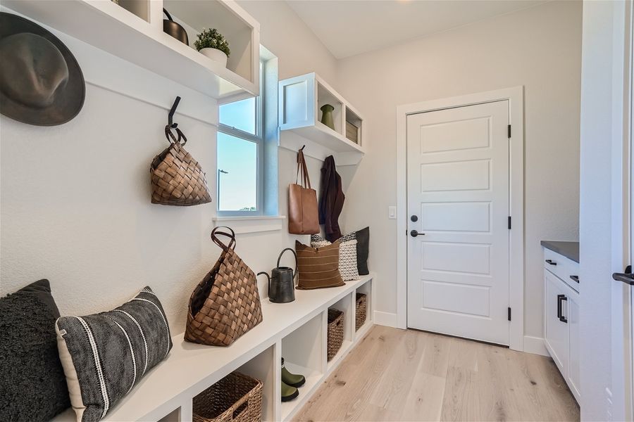 A room with a white door and shelves with baskets and a white door. A room with a white door and shelves with baskets and a white door.