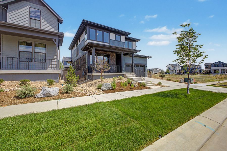 Front exterior of a new home in West Grange, Longmont, CO, highlighting curb appeal (Image 18). Front exterior of a new home in West Grange, Longmont, CO, highlighting curb appeal (Image 18).