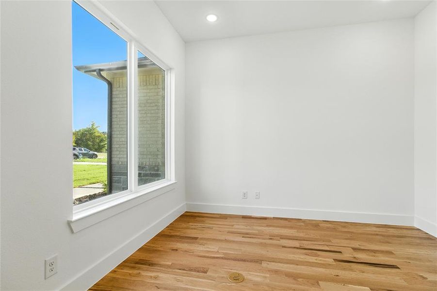 Empty room featuring light wood-style floors and recessed lighting