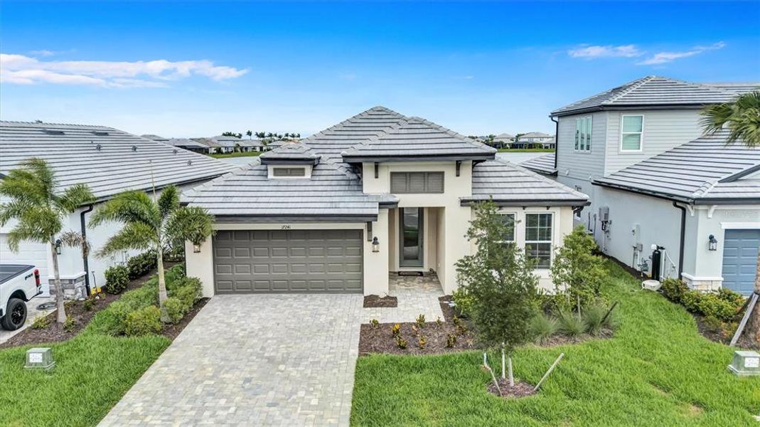Front exterior of a new home in Sweetwater at Lakewood Ranch, Bradenton, FL, highlighting curb appeal (Image 21). Front exterior of a new home in Sweetwater at Lakewood Ranch, Bradenton, FL, highlighting curb appeal (Image 21).