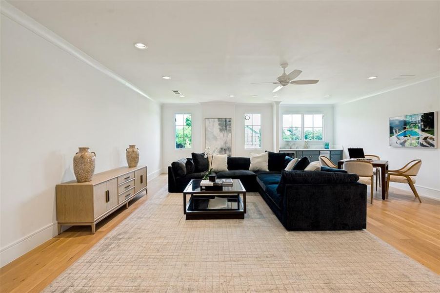 Spacious interior featuring light-toned wood flooring, recessed lighting, and crown molding