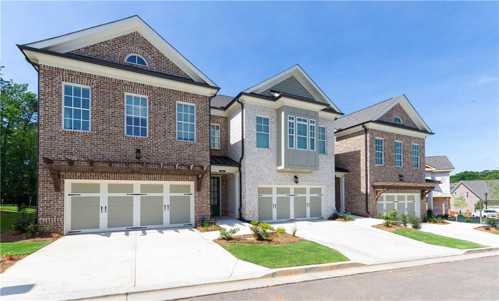 Front exterior of a new home in Waterside Townhomes, Peachtree Corners, GA, highlighting curb appeal (Image 2). Front exterior of a new home in Waterside Townhomes, Peachtree Corners, GA, highlighting curb appeal (Image 2).