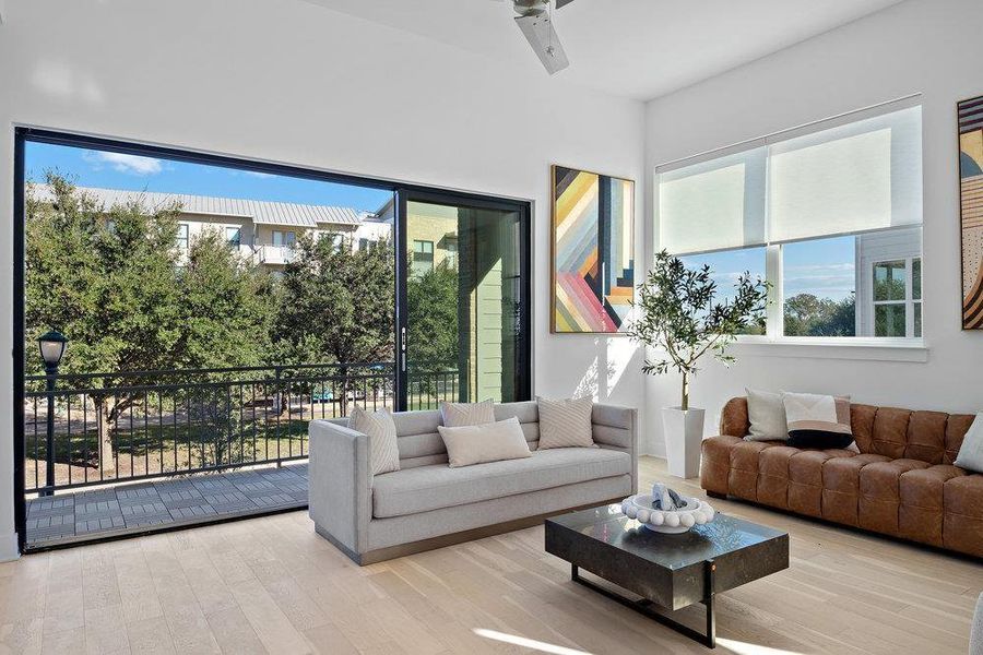 Living room featuring wood finished floors and plenty of natural light Living room featuring wood finished floors and plenty of natural light