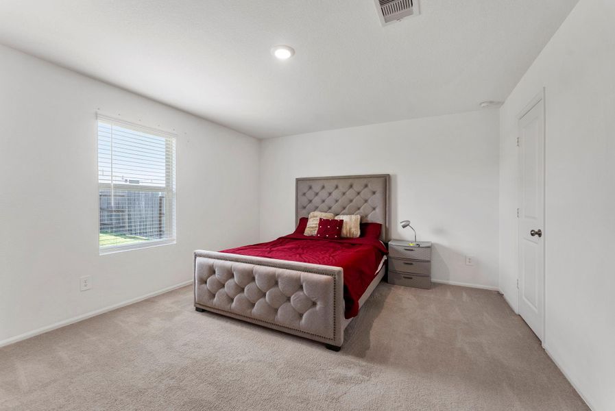 The primary bedroom overlooks the backyard.