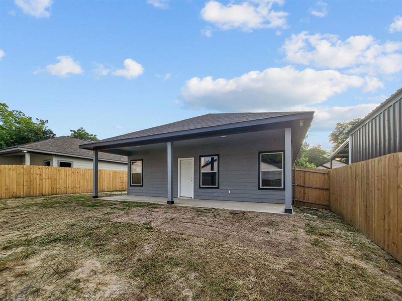Back of house with roof with shingles, a fenced backyard, and a patio area Back of house with roof with shingles, a fenced backyard, and a patio area