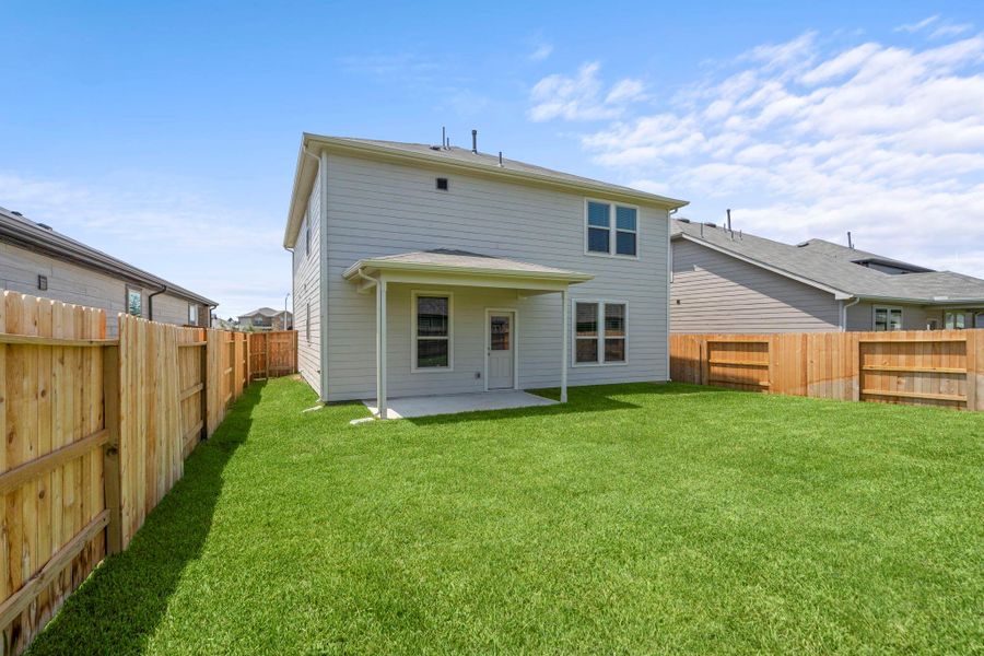 Front exterior of a new home in Mavera, Conroe, TX, highlighting curb appeal (Image 1).