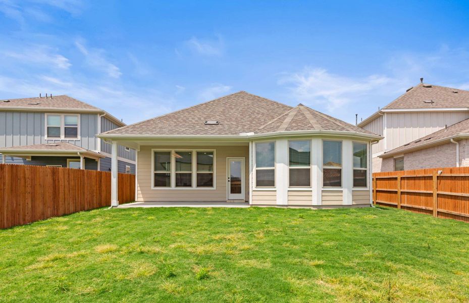 Front exterior of a new home in Santa Rita Ranch, Liberty Hill, TX, highlighting curb appeal (Image 1).