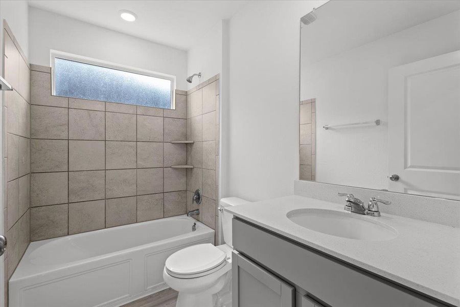A well-appointed bathroom offers a clean aesthetic with a vanity, modern fixtures, and a shower-tub combination. A well-appointed bathroom offers a clean aesthetic with a vanity, modern fixtures, and a shower-tub combination.