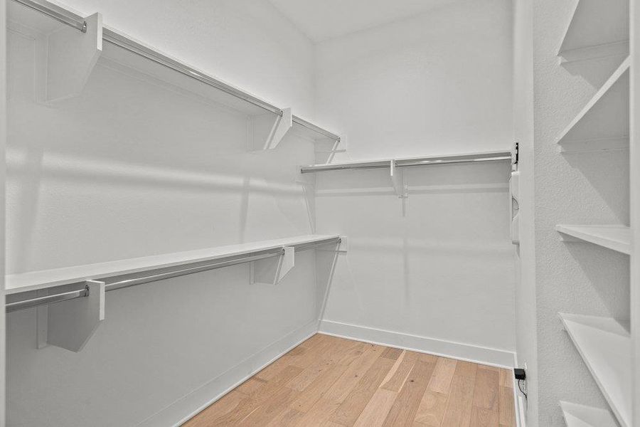 Ample shelving and hanging space in this well-organized walk-in closet. Ample shelving and hanging space in this well-organized walk-in closet.