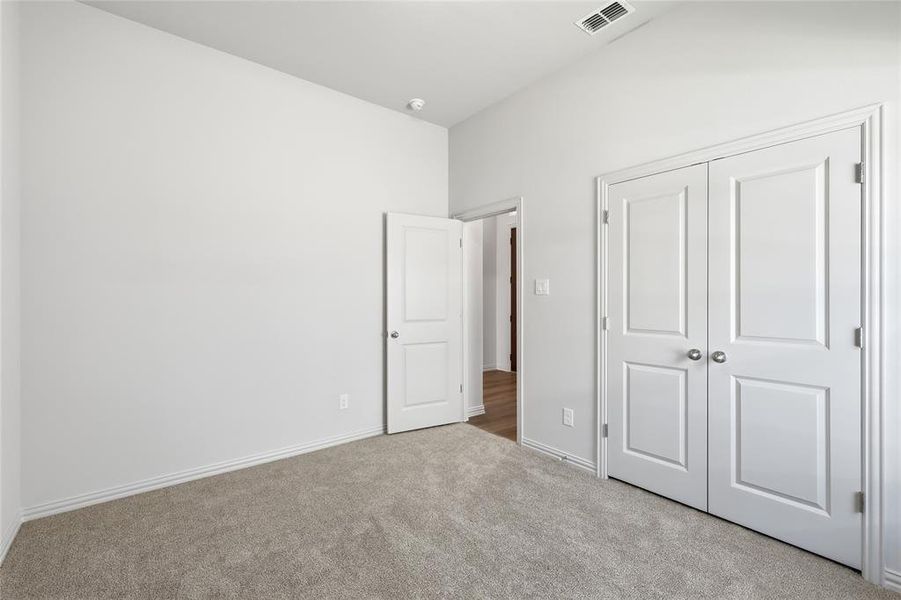 Unfurnished bedroom with carpet floors and a closet