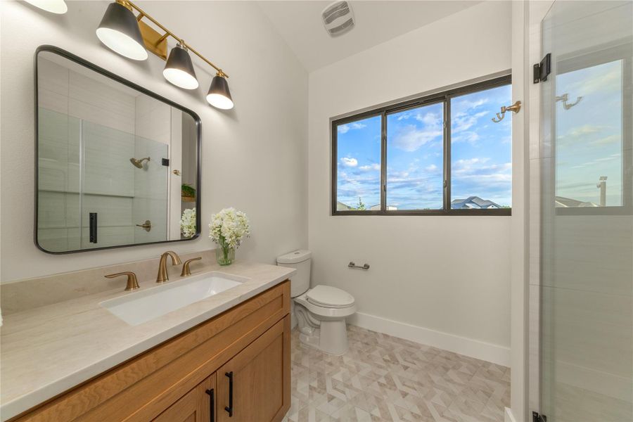Full bath featuring a shower stall and vanity