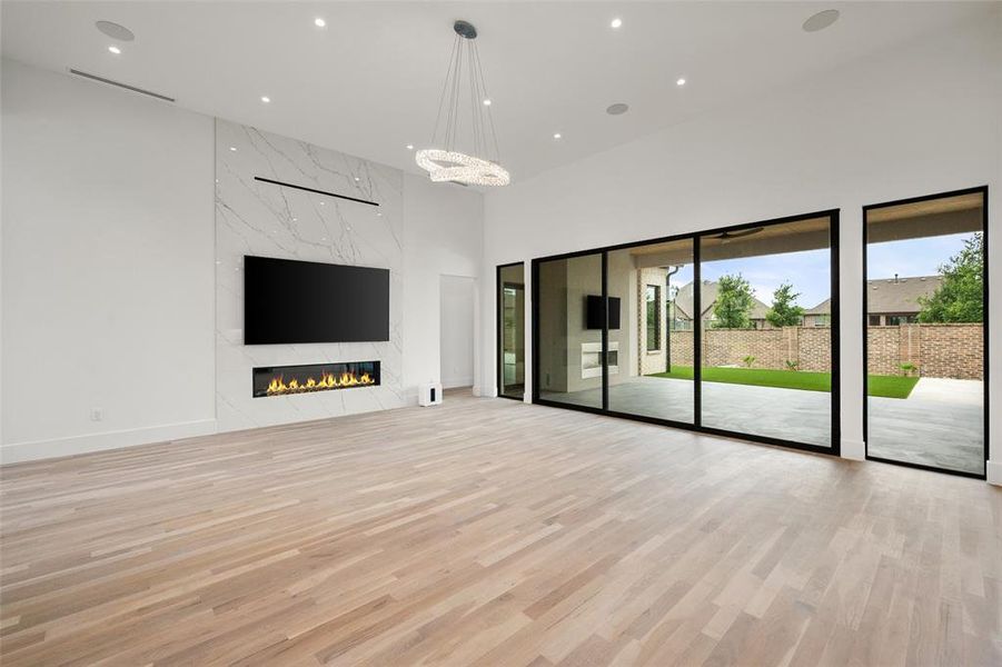 Living Room with Fireplace & Oversized Windows Living Room with Fireplace & Oversized Windows