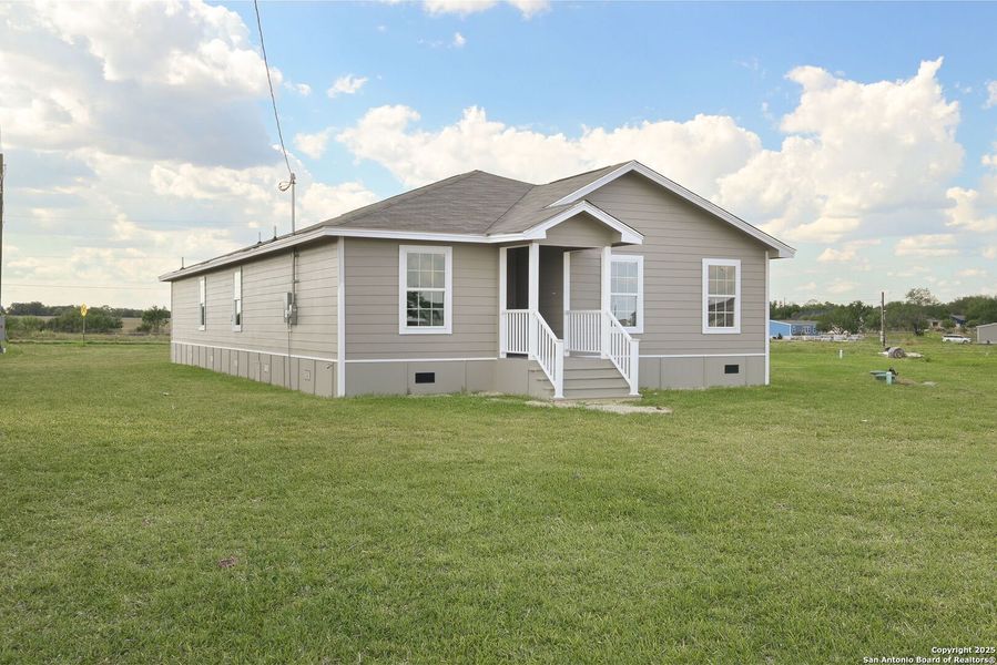 Front exterior of a new home in , Atascosa, TX, highlighting curb appeal (Image 12). Front exterior of a new home in , Atascosa, TX, highlighting curb appeal (Image 12).