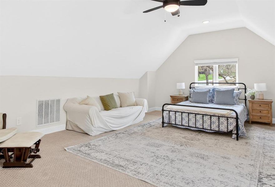 Bedroom featuring ceiling fan and light colored carpet Bedroom featuring ceiling fan and light colored carpet
