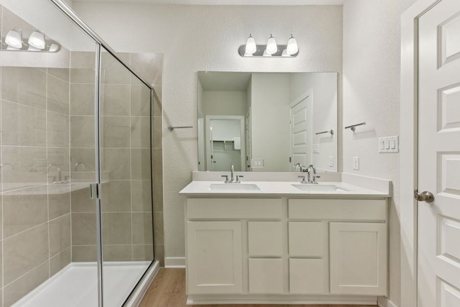 A bathroom with a glass shower. A bathroom with a glass shower.