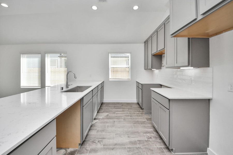 The extended counter area adds both practicality and style, making meal preparation a breeze. Every detail is thoughtfully designed to enhance the kitchen's functionality and aesthetic appeal.