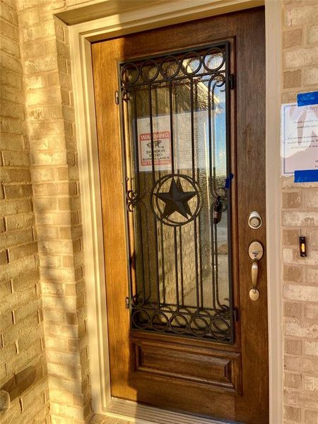 Great first impression with iron & glass front door.