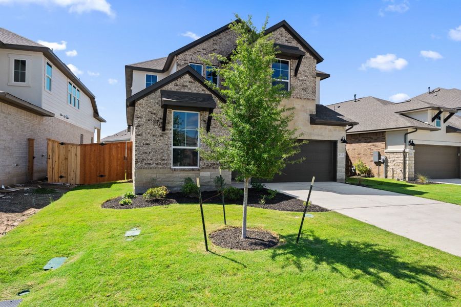 Front exterior of a new home in Lariat, Liberty Hill, TX, highlighting curb appeal (Image 24).