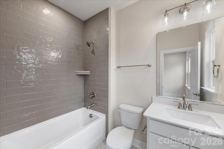 Secondary Bathroom with Tiled Wall above Tub