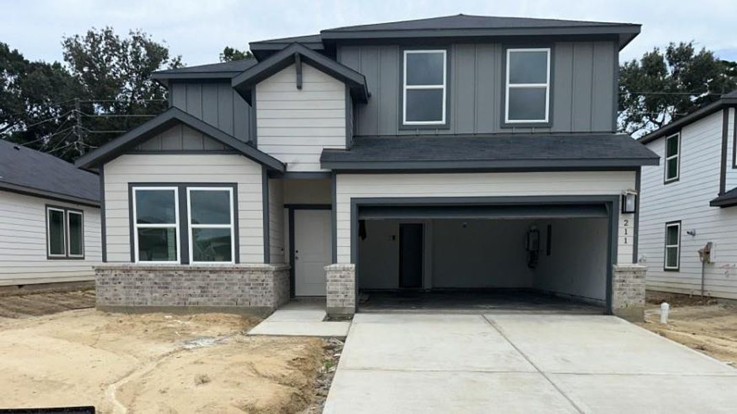 Front exterior of a new home in Newport Grove 50s, Crosby, TX, highlighting curb appeal (Image 1).