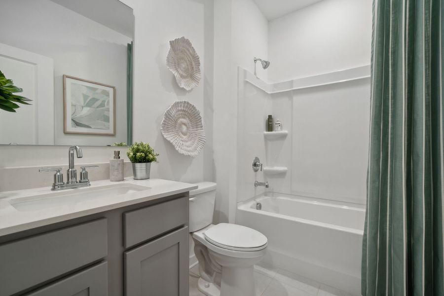 A bathroom with a tub toilet and sink.