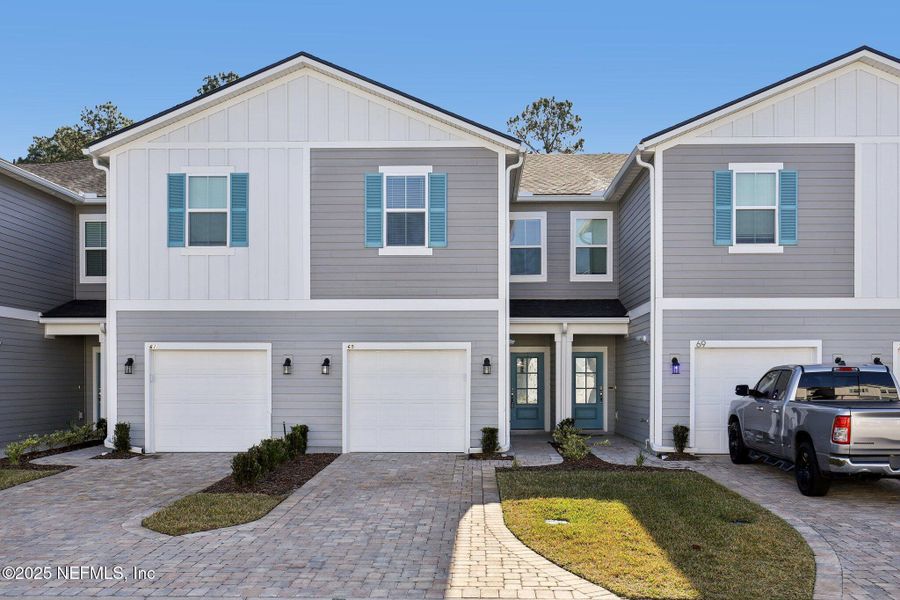 Front exterior of a new home in Brandon Lakes at Silver Landing, St. Augustine, FL, highlighting curb appeal (Image 23).
