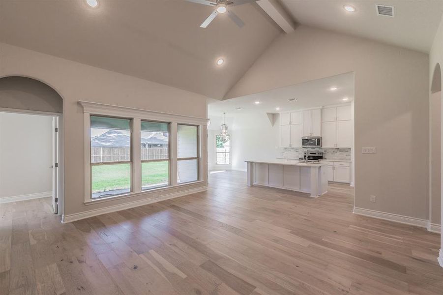 Kitchen featuring ceiling fan, white cabinetry, appliances with stainless steel finishes, and light hardwood / wood-style flooring