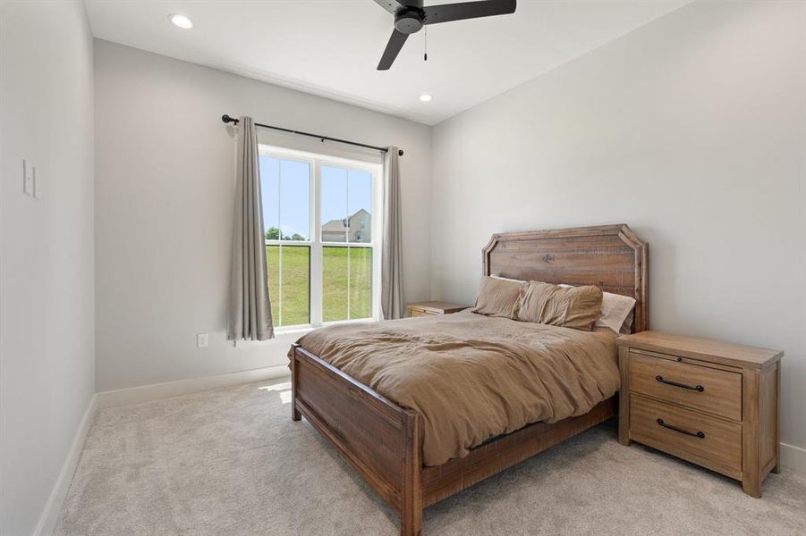 Bedroom featuring ceiling fan and light colored carpet