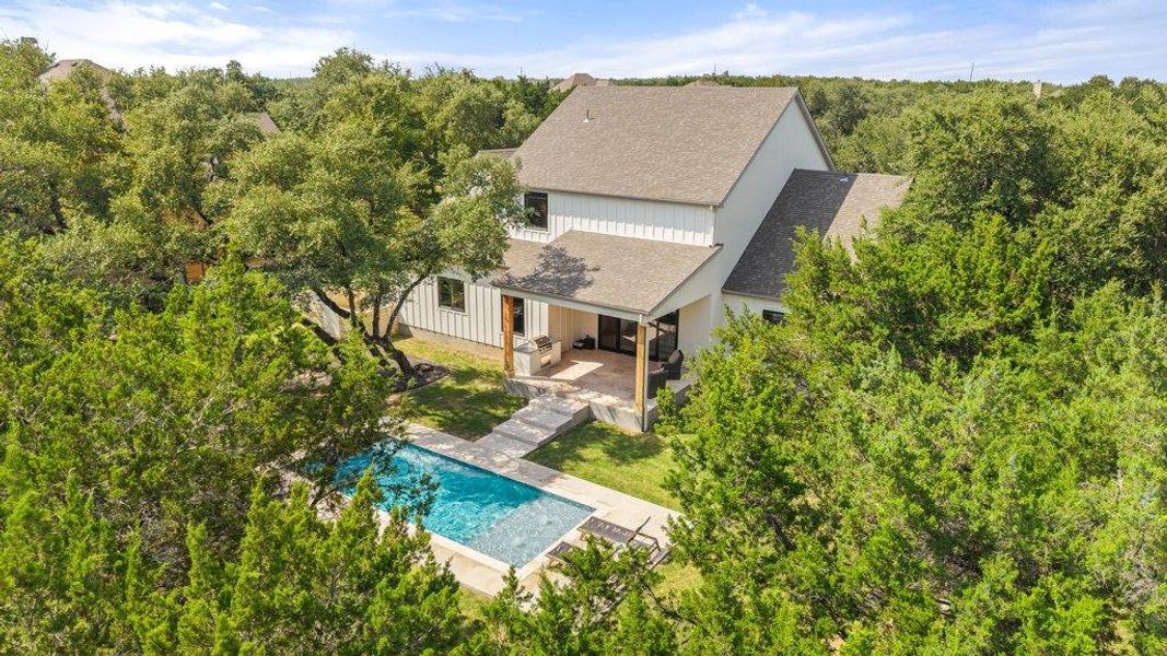 An inviting backyard oasis offers a sparkling pool and a covered patio for relaxed outdoor living. An inviting backyard oasis offers a sparkling pool and a covered patio for relaxed outdoor living.