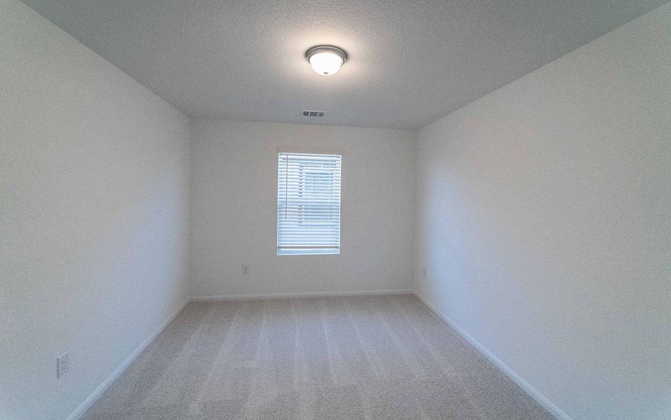 Spare room with light colored carpet and a textured ceiling Spare room with light colored carpet and a textured ceiling