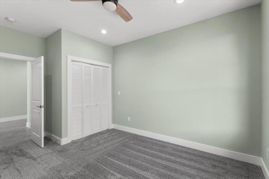 Bedroom number 3  featuring carpet floors, a closet, recessed lighting, and a ceiling fan